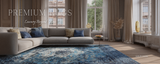 Living room with a gray sectional sofa and blue patterned rug, featuring 'Premium Rugs' branding.