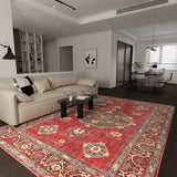 Living room with a red patterned rug, beige sofa, and coffee table.