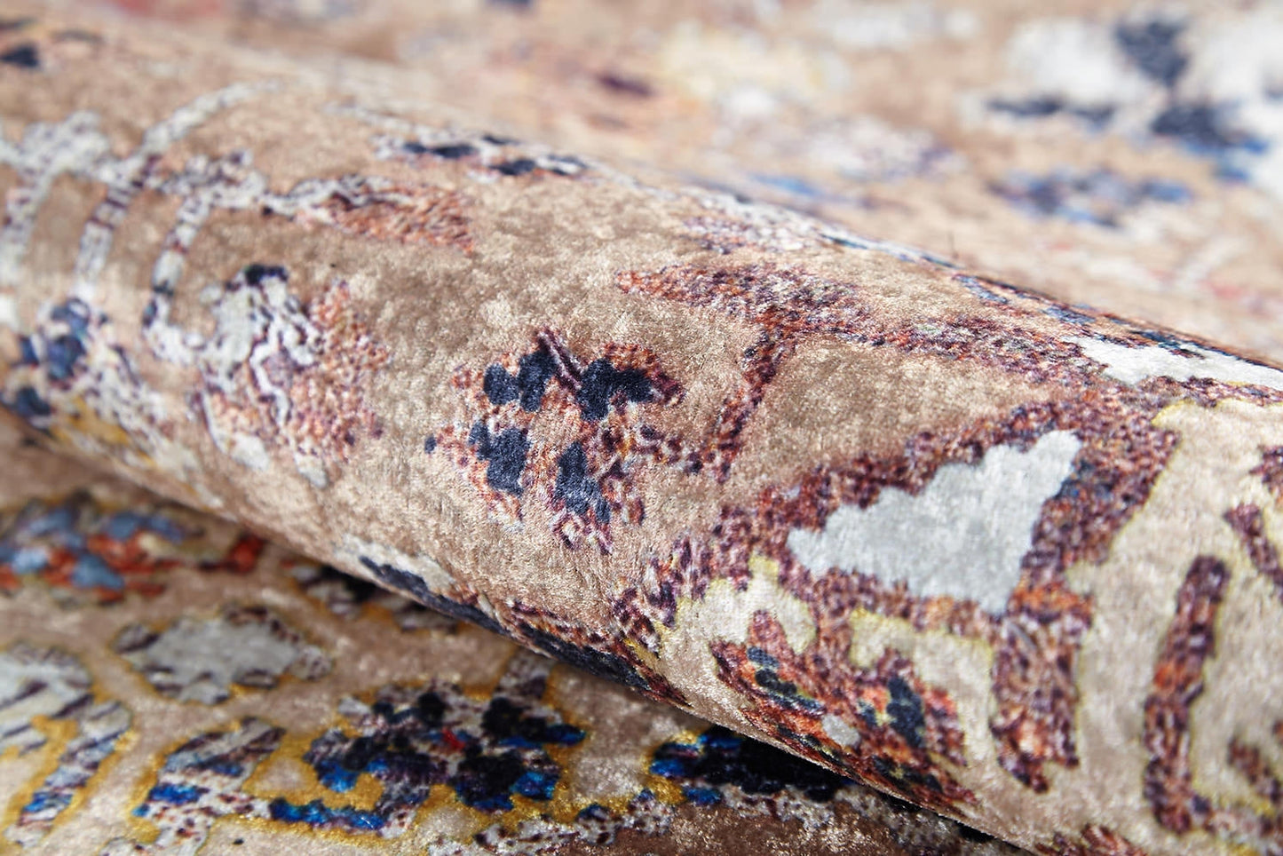 A close-up of Native Nature's Washable Rug - JR1666 (Custom Size), featuring a soft, velvety texture and an abstract pattern in brown, cream, beige, blue, yellow, and red—perfect for high-traffic areas.