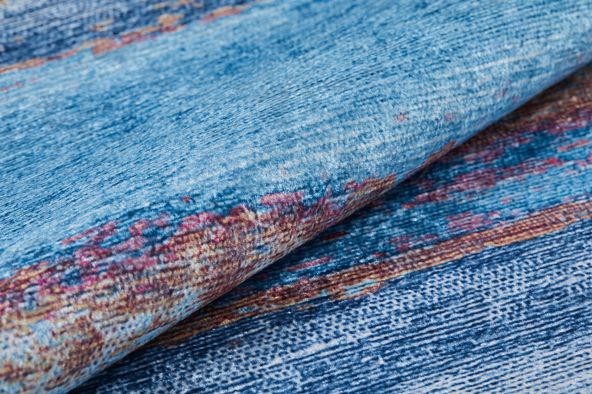 Close-up of Abstract Elegance - Machine-Washable Rug JR87, featuring textured blue tones with multicolored accents (red, pink, yellow); woven look; perfect for high-traffic areas and easy to maintain with machine washing.