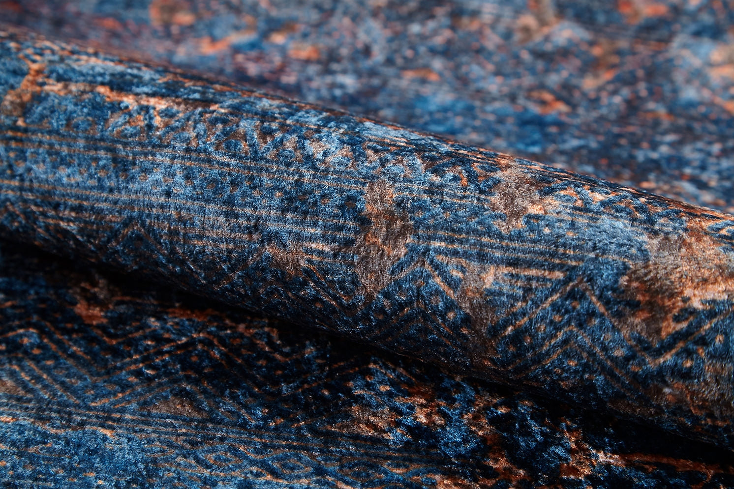Close-up of Abstract Harmony - Machine-Washable Rug JR1882 in blue with brown geometric patterns and faded designs, highlighting its soft, velvety texture. Ideal for allergy-sensitive homes thanks to its washable fabric.