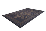 The Ancient Legacy - Washable Rug - JR1890 is a rectangular, dark-colored rug with an ornate faded gold geometric and floral design and decorative border, ideal for high-traffic areas, shown angled on a white background.