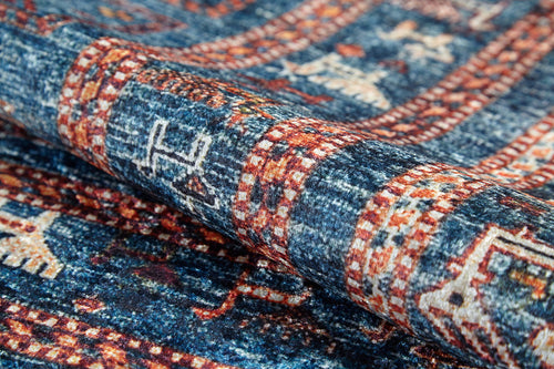 Load image 1 in gallery view. Close-up of the Berber Beauty - Washable Rug - JR5092, folded to show its blue pattern with red and cream accents. Geometric and traditional motifs highlight its texture—ideal for high-traffic areas and easy to clean.