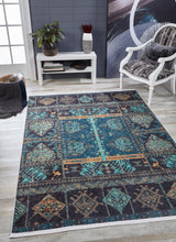 A modern living room features the Blossoming Bazaar - Washable Rug - JR1862 in blue and teal, perfect for high-traffic areas, paired with a white bench, plants, décor accents, and a white armchair with a black patterned cushion on light wood floors.