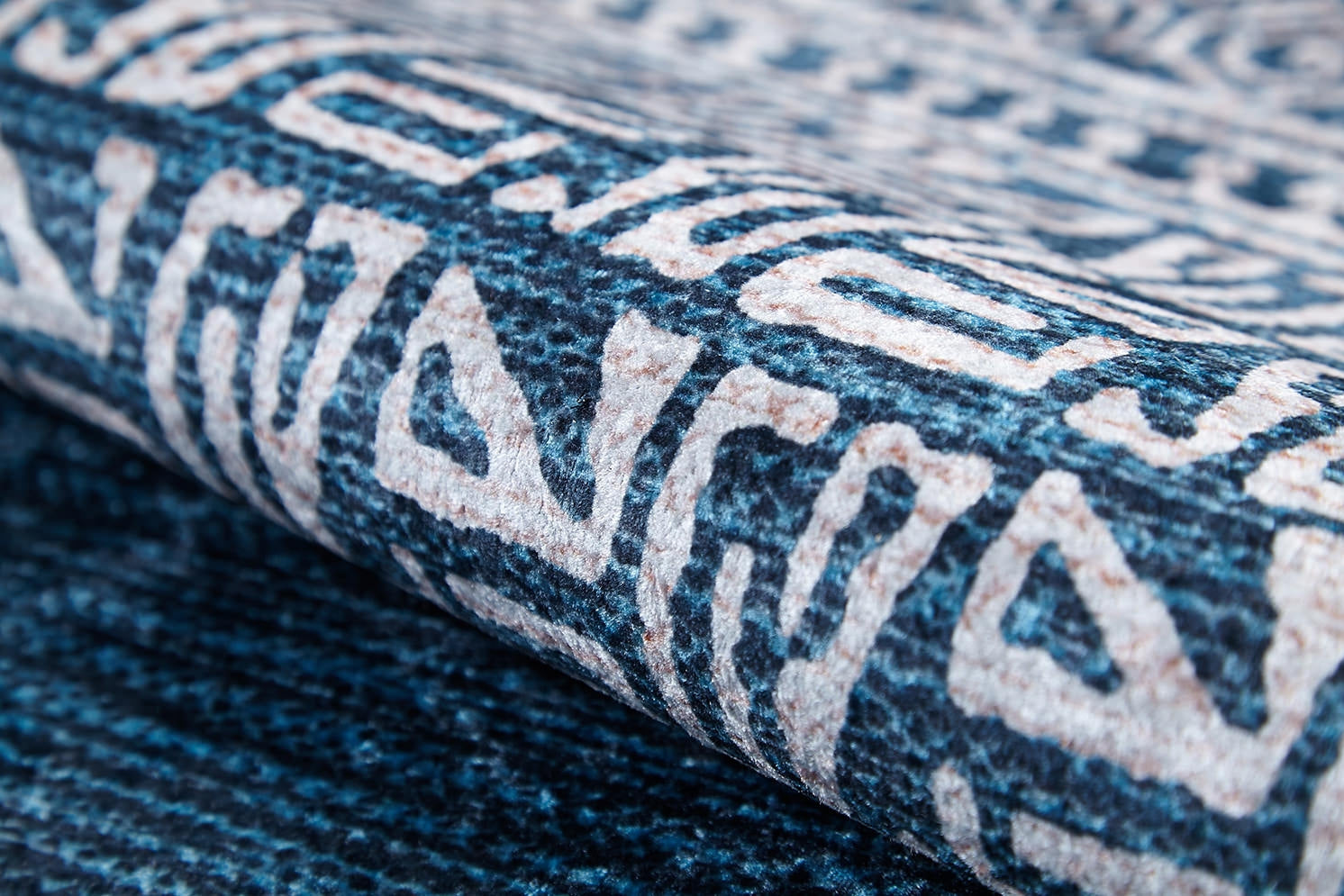 A close-up of the Bohemian Retreat - Washable Rug - JR1589 highlights its textured blue and cream geometric patterns—durable, stylish, and ideal for high-traffic areas.