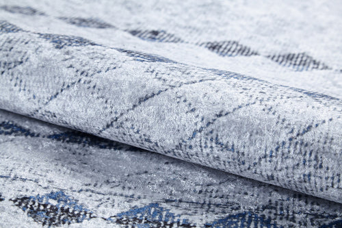 Load image 1 in gallery view. Close-up of the Bohemian Reverie - Washable Rug - JR1974 (Outlet) US, shown folded with a soft, textured surface and subtle diamond pattern in gray, blue, and black—ideal for high-traffic spaces.
