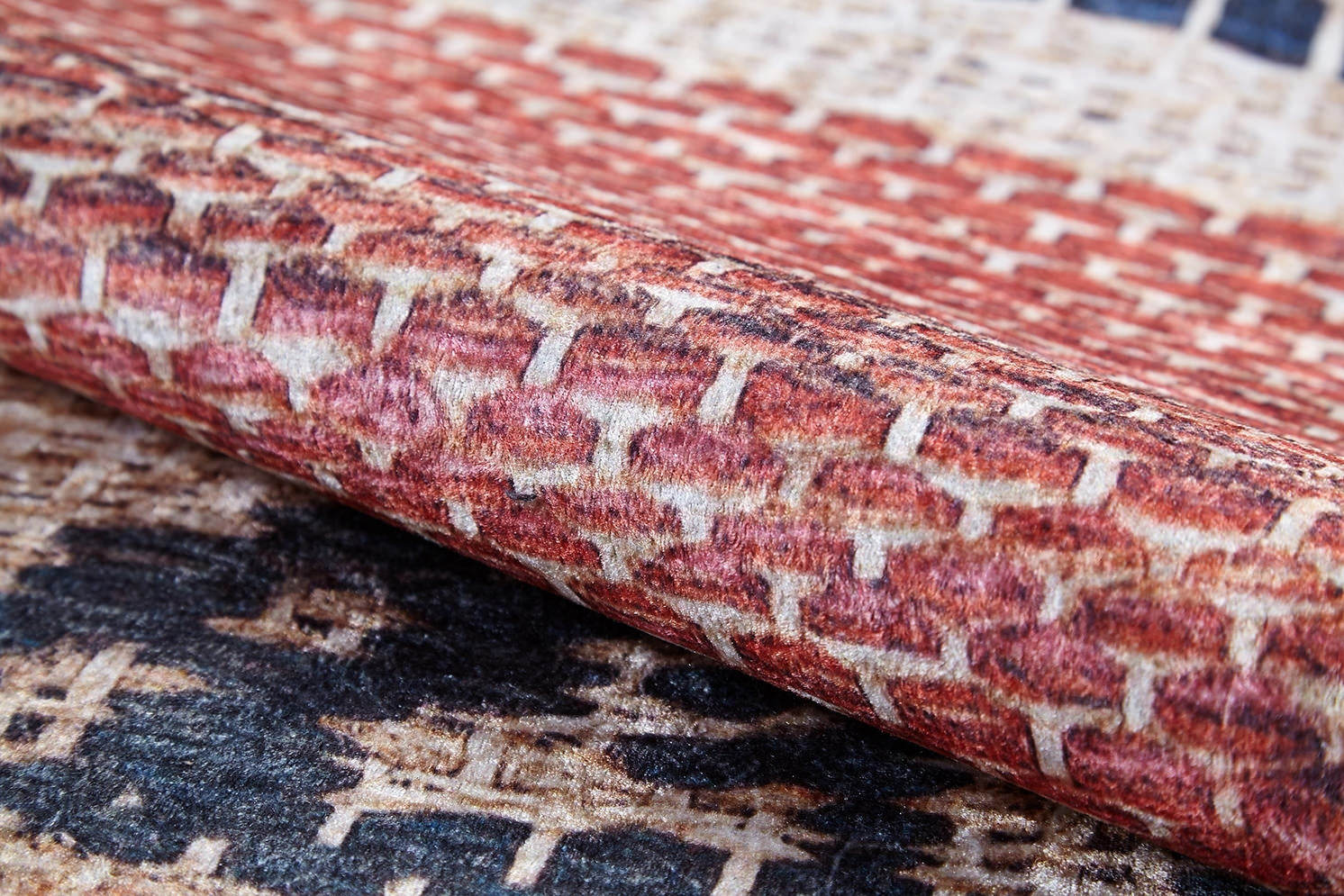 Close-up of the Boho Bliss - Washable Rug - JR1723 shows its textured flat weave and geometric pattern in red, cream, and beige tones—highlighting the intricate design and raised surface for stylish, easy-care decor.