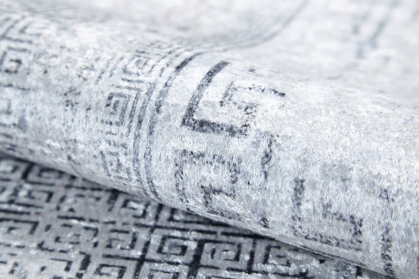 A close-up of the Bold Borderline - Washable Rug - JR1984 in gray-anthracite, featuring a subtle geometric Greek key pattern and soft texture—durable and stylish for high-traffic areas.