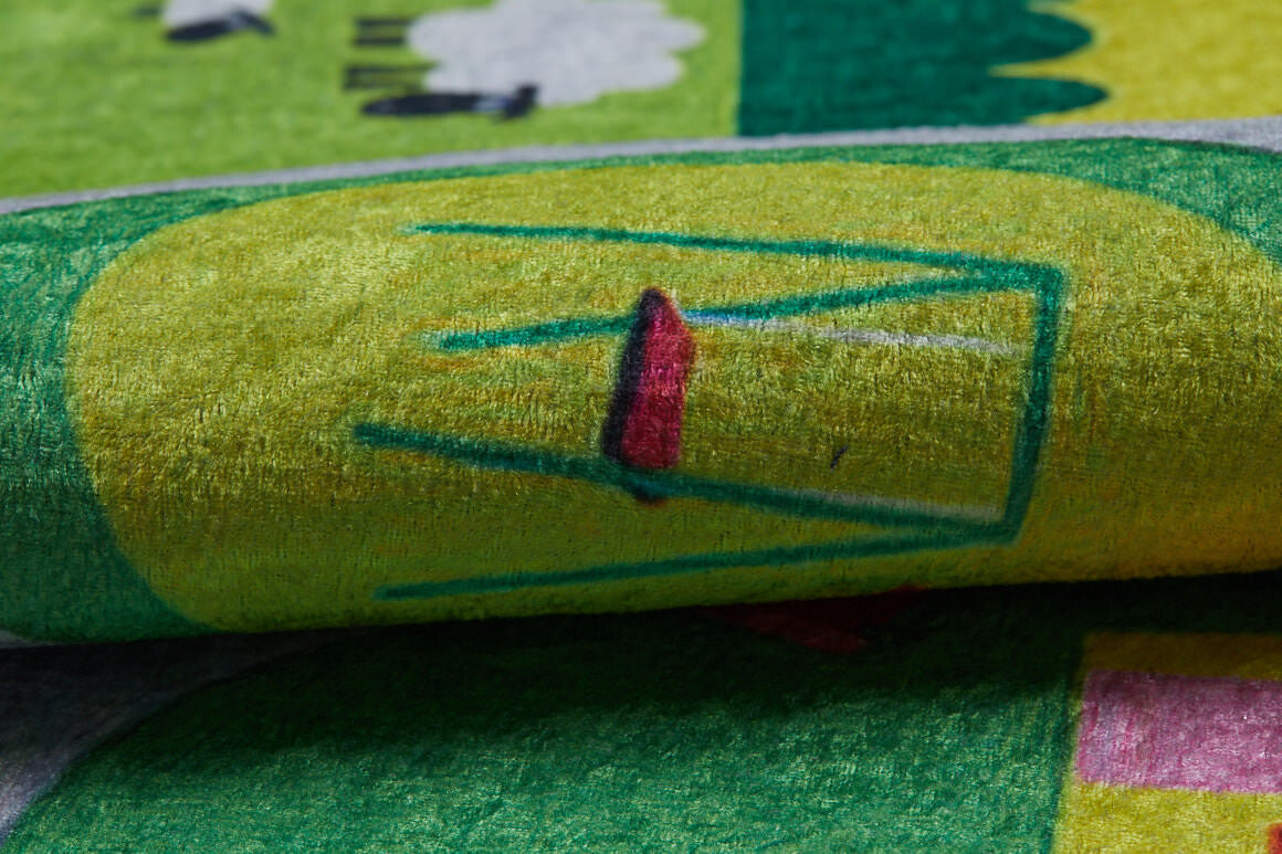 A close-up of the City Adventure - Machine-Washable Rug JRC039, a colorful, textured flat weave featuring a simple red and green chair on yellow, with abstract and nature-inspired designs in the background.