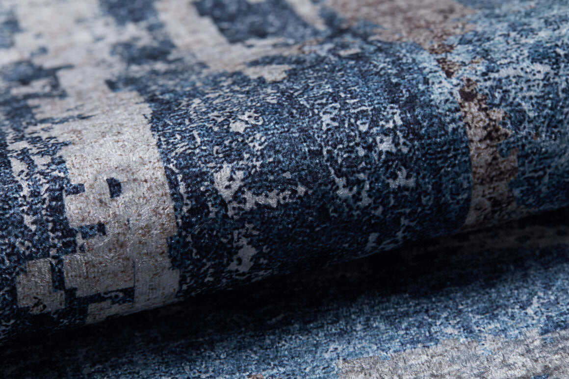 Close-up of the Classic Bordered - Washable Rug - JR1197, featuring a textured surface with an abstract blue, gray, and beige pattern—ideal for high-traffic and allergy-sensitive spaces, highlighting detailed fibers and subtle variations.