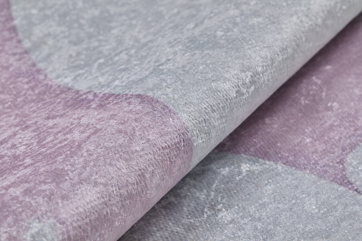Close-up of the Cosmic Naptime - Machine-Washable Rug JRC032, showcasing its soft, velvety lavender and light gray tones with a subtle abstract pattern—bringing gentle elegance reminiscent of soft pink rugs.