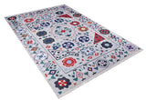 The Desert Drift - Washable Rug - JR1523 features a rectangular, light gray background with colorful red, blue, green, orange, and white geometric and floral patterns plus a flower and diamond border—perfect for high-traffic spaces.