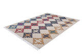 The Desert Mirage - Washable Rug - JR5033 features a rectangular flat weave with interlocking X-shapes in blue, red, and tan on a light background. Fringed edges on the short sides enhance its charm, and it's allergy-friendly.