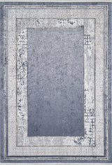 The Dramatic Boundaries - Washable Rug - JR1810 features a rectangular blue design with a faded blue-gray center, worn off-white Greek key border, and distressed edges—perfect for high-traffic spaces needing vintage charm.