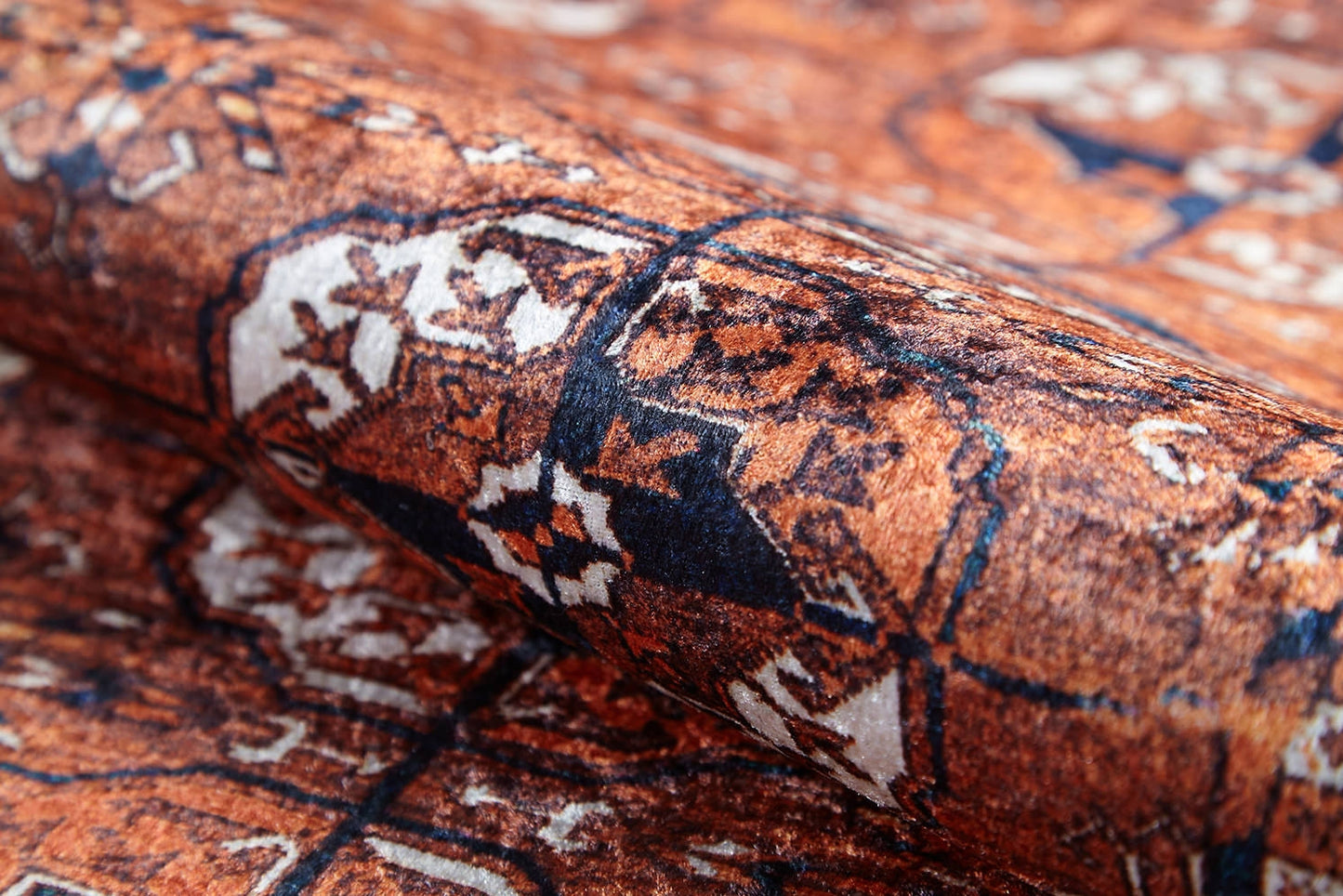 A close-up of the Earthy Enigma - Washable Rug (JR1937), showing its intricate Persian-style geometric and floral patterns in rust orange, navy blue, and cream—perfect for high-traffic areas with a visible woven texture.