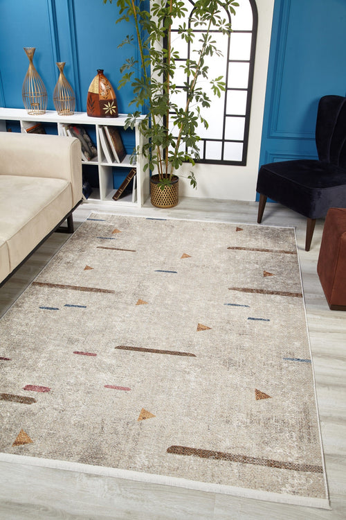 Load image 1 in gallery view. A modern living room featuring the Ebony Ivory - Washable Rug - JR1994, perfect for high-traffic areas, paired with a cream sofa, dark blue chair, brown ottoman, potted plant, shelves with vases, and a window-style mirror on a blue paneled wall.