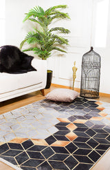 A modern living room showcases the Geometric Harmony - Washable Rug - JR1271, a light sofa with a black fur throw, potted plant, beige floor pillow, gold accents, and an empty black birdcage.