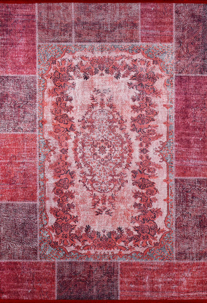 The Golden Wonder - Washable Rug - JR306 is a rectangular red rug with a patchwork border in burgundy and red, featuring a pink and red ornate floral medallion. It's durable for high-traffic areas and easy to clean—machine washable for convenience.