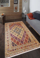 The Grandiose Grace - Washable Rug - JR44, featuring diamond designs, adds color to a modern living room with dark wood floors, a gray sofa, orange throw, small table, décor pieces, and framed art—perfect for high-traffic areas.