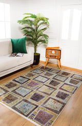 A living room with a white sofa, green cushion, potted plant, vintage radio on a stand, open magazine, and the Gridiron Glow - Washable Rug - JR183—perfect for high-traffic areas. White walls and large windows invite natural light.