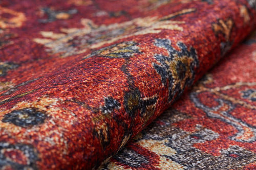 Load image 1 in gallery view. Close-up of the Historic Hues - Washable Rug - JR898 (Outlet) US, featuring rich red hues with orange, yellow, and dark blue patterns; intricate designs and a rolled edge—ideal for high-traffic spaces.