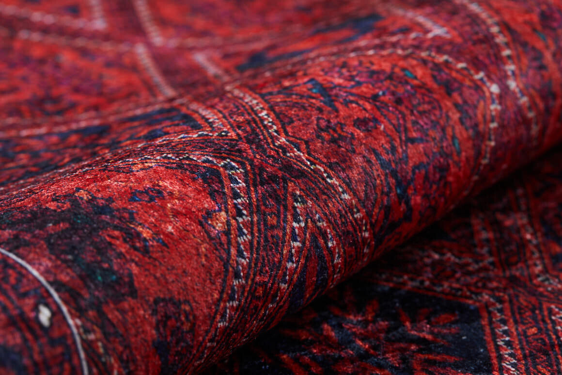 Close-up of the Imperial Impressions - Washable Rug - JR1132, featuring rich red tones and detailed geometric and floral patterns; part of the washable rug is rolled up, making it ideal for high-traffic areas.