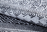 The Indie Impressions - Washable Rug - JR1648 features black geometric and spiral designs on a light gray background, offering bold style that's easy to maintain—perfect for high-traffic areas.