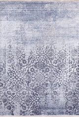 The Intricate Scroll - Washable Rug - JR342 features a rectangular shape, a distressed blue-gray background, and an ornate dark blue floral pattern that gradually fades—ideal for high-traffic spaces.