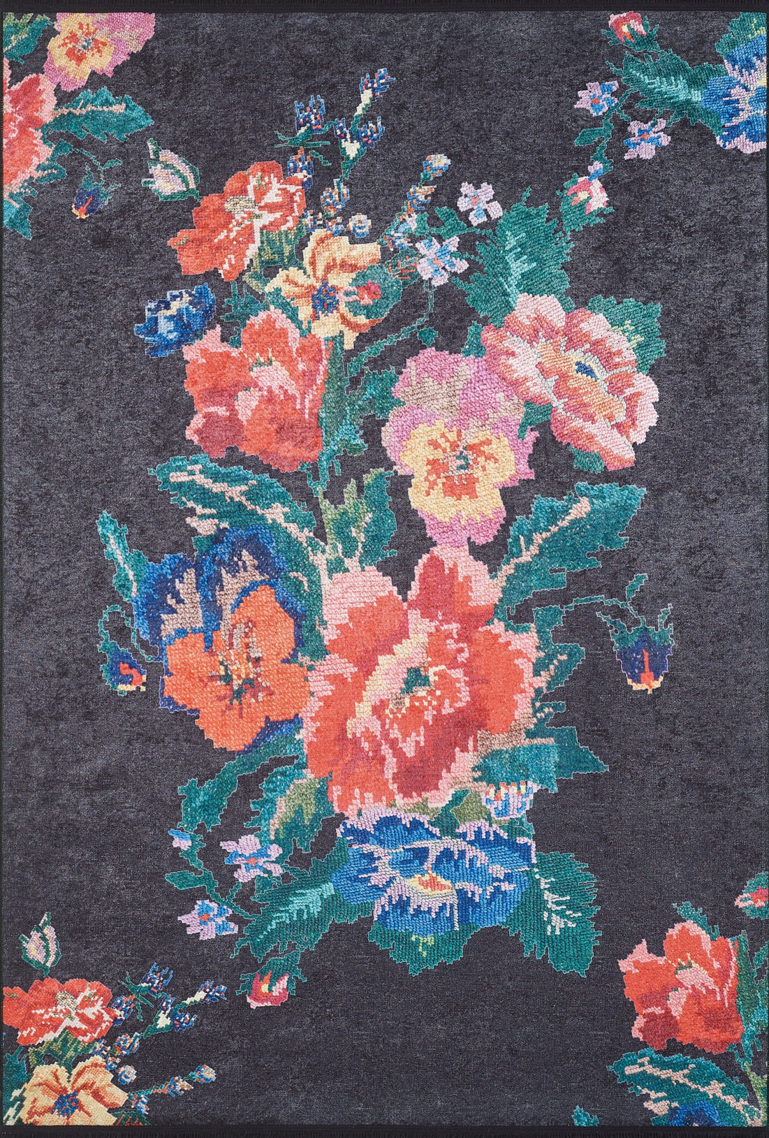 The Meadow Dream - Washable Rug - JR2001 features a dark, textured design with a pixelated large floral pattern in red, yellow, blue, pink, and orange with green leaves—perfect for high-traffic areas.