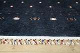 A close-up of Midnight Majesty - Machine-Washable Rug (JRS5052), featuring dark blue tones, small geometric patterns, a white edge, and red, white, and blue fringe—perfect for high-traffic wooden floors.