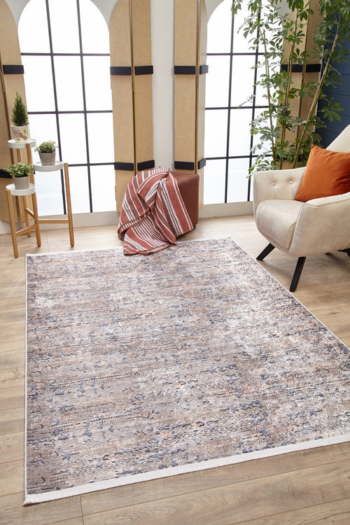 Load image 1 in gallery view. A modern living room featuring the Modern Enigma - Machine-Washable Rug JR1883 in light patterns on wood floors, a cream armchair with an orange pillow, potted plants, and large arched windows—a stylish choice for high-traffic areas.