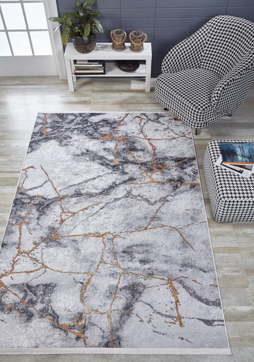 Load image 1 in gallery view. A modern living room features the Opulent Veins - Machine-Washable Rug JR1593 in gray-anthracite with gold veining, a black-and-white houndstooth armchair, ottoman, small white table with decor, plant, and light wood floors—ideal for high-traffic spaces.