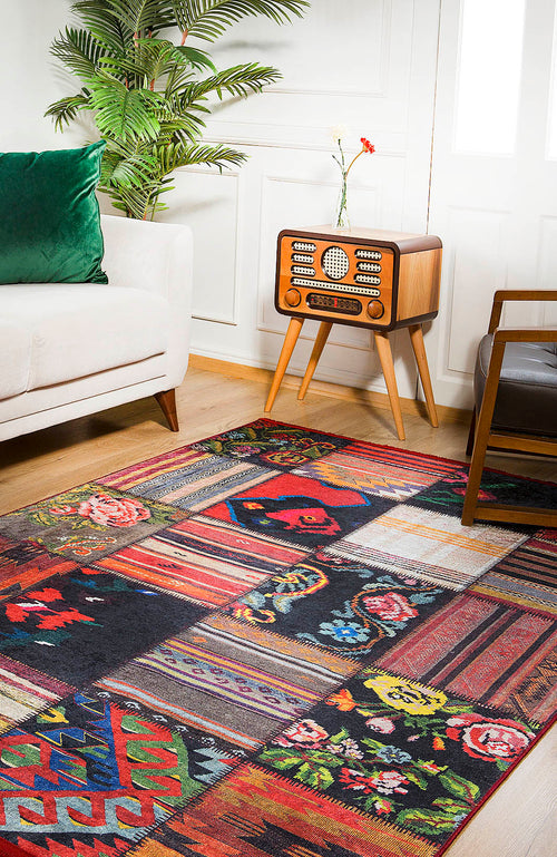 Load image 1 in gallery view. A living room featuring the Petal Paradise - Washable Rug - JR315, a white sofa with green pillow, retro wooden radio on a small table, potted plant, and brown armchair—ideal for high-traffic areas.