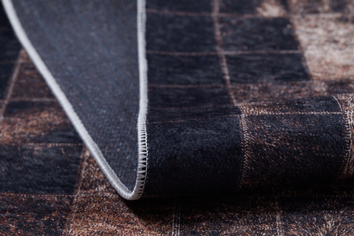 A close-up of the Pinstripe Paradise - Washable Rug (JR1004) in a dark tone features a subtle square pattern, one edge lifted to reveal stitching and the underside.