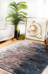 A modern living room features a beige sofa, leafy potted plant, decorative trophy, and large framed horse head artwork on the floor. The wooden floor is covered by the Pixelated Paradise - Machine-Washable Rug JR902 in bronze and brown.