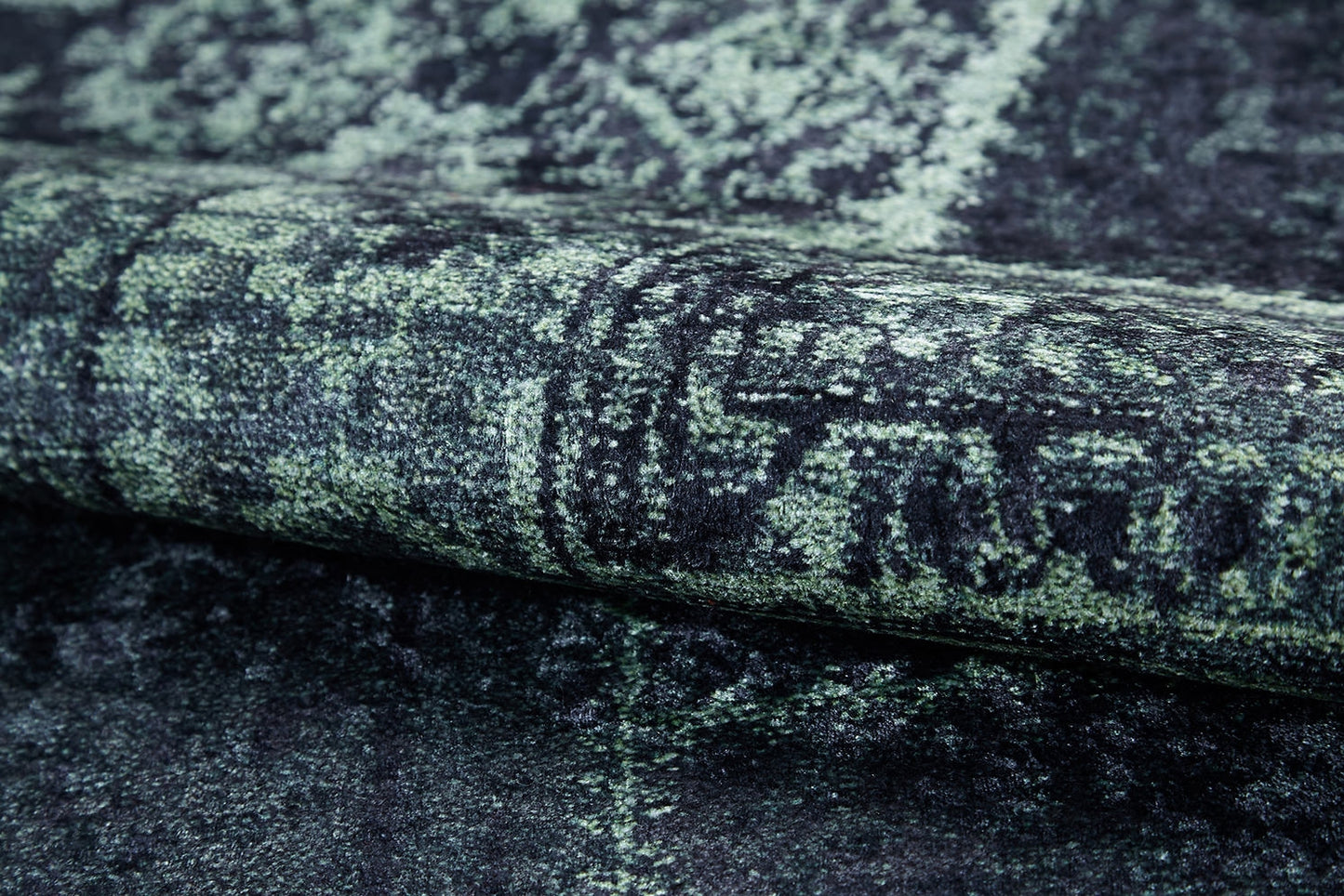 Close-up of the Rustic Remix - Washable Rug - JR1710, featuring a dark green and black intricate pattern and distressed vintage look—ideal for stylishly updating high-traffic spaces.