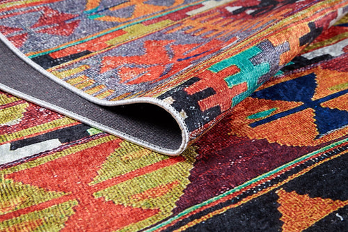 Load image 1 in gallery view. A close-up of the Serene Sahara - Washable Rug - JR1959, featuring multicolor geometric patterns and a folded corner to show its durable front and back textures—ideal for high-traffic spaces.