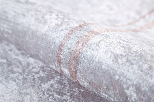 Load image 1 in gallery view. A close-up of the Sophisticated Edging - Washable Rug - JR1738 shows its light gray, textured surface with a subtle sheen and faint, curved beige lines for an elegant look.