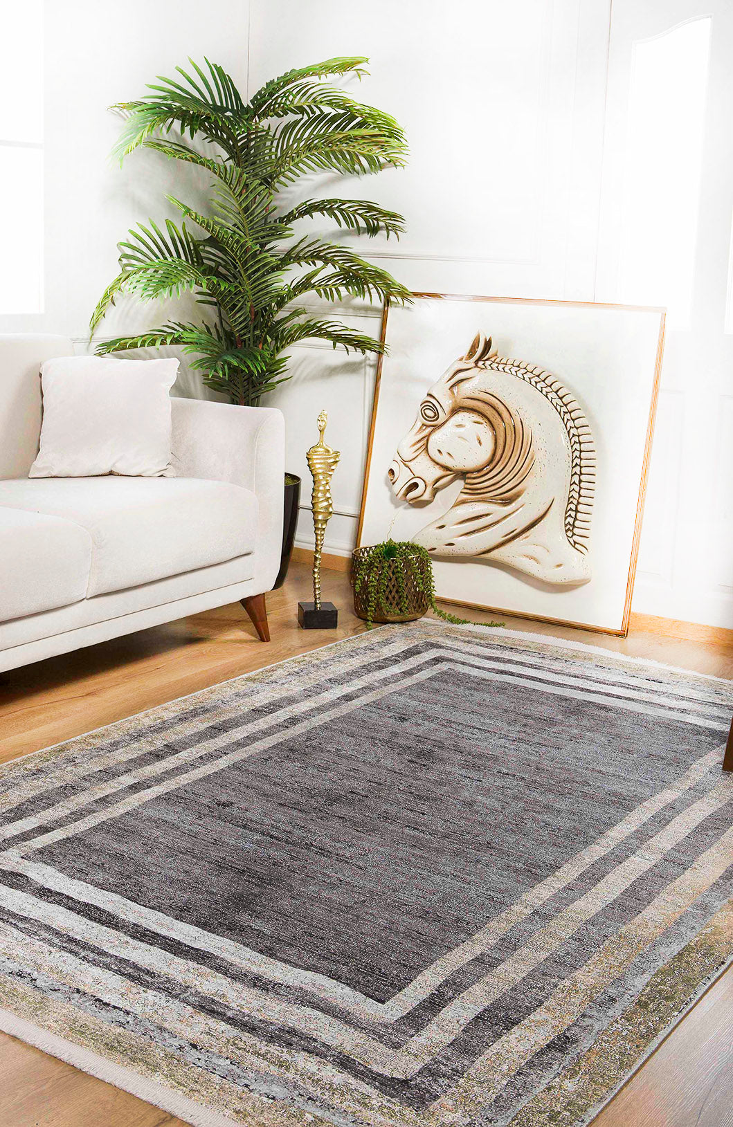 A modern living room with a light sofa, leafy plant, horse artwork on the floor, a decorative trophy, and the Sophisticated Trellis - Washable Rug - JR1194—great for high-traffic and allergy-friendly homes.