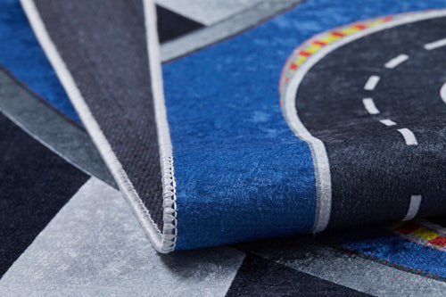 Load image 1 in gallery view. Close-up of the Speedway Sprouts - Machine-Washable Rug JRC068, a folded play mat with a colorful curved road, blue and gray sections, and stitched edging—ideal for high-traffic areas.