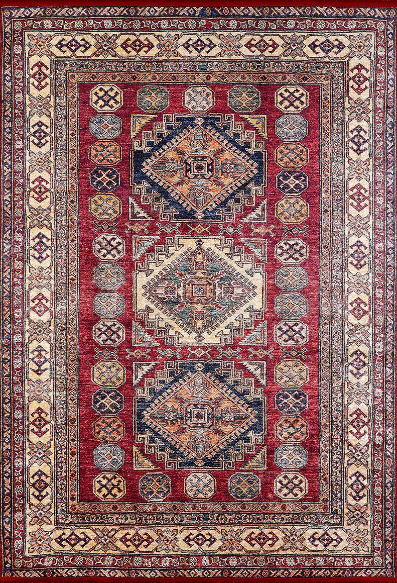The Time-Honored Textures - Washable Rug - JR40 is a rectangular red rug with a rich background, geometric shapes, and detailed cream, blue, and gold borders. Its central diamond motifs and sturdy design make it ideal for high-traffic areas.