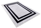 The Timeless Border - Washable Rug - JR572 features a rectangular, durable design with a light gray background and two concentric black borders for a modern geometric look. Shown angled on a white background.