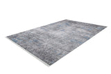 The Timeless Embellishment - Washable Rug - JR1943 is a rectangular flat weave rug with a distressed gray and blue pattern, subtle textured design, allergy-friendly materials, and fringed edges on the shorter sides. Shown on a white background.
