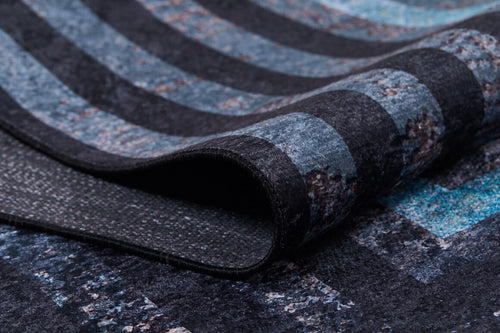 Load image 1 in gallery view. Close-up of the Traditional and Timeless - Washable Rug - JR1408, showing its textured surface with curved fold and a dark blue, black, and gray striped pattern—perfect for high-traffic areas.