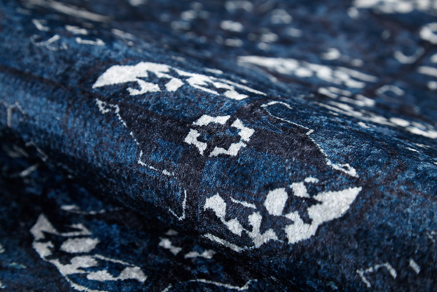 Close-up of the Tribal Trail - Washable Rug - JR1939, featuring blue and white raised texture with abstract and floral patterns—durable and perfect for high-traffic areas.