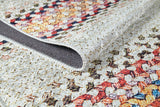 Close-up of the Vibrant Rainbow - Machine-Washable Rug (JR5001) with a multicolored diamond pattern in red, orange, and black. Detailed stitching and folded edge reveal the underside—durable and ideal for high-traffic areas.