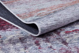 A close-up of the Vintage Brushed - Washable Rug - JR143 in grey, red, and purple shades shows one corner lifted to display the underside and edge stitching.