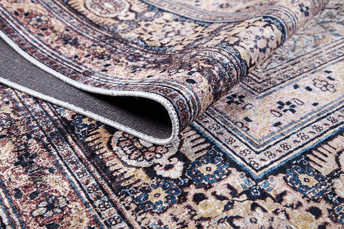 Load image 1 in gallery view. The Vintage Charm - Washable Rug - JR1933 features intricate floral and geometric patterns in beige, blue, and brown. A folded corner reveals the underside. Durable stitched edges make it perfect for high-traffic areas.