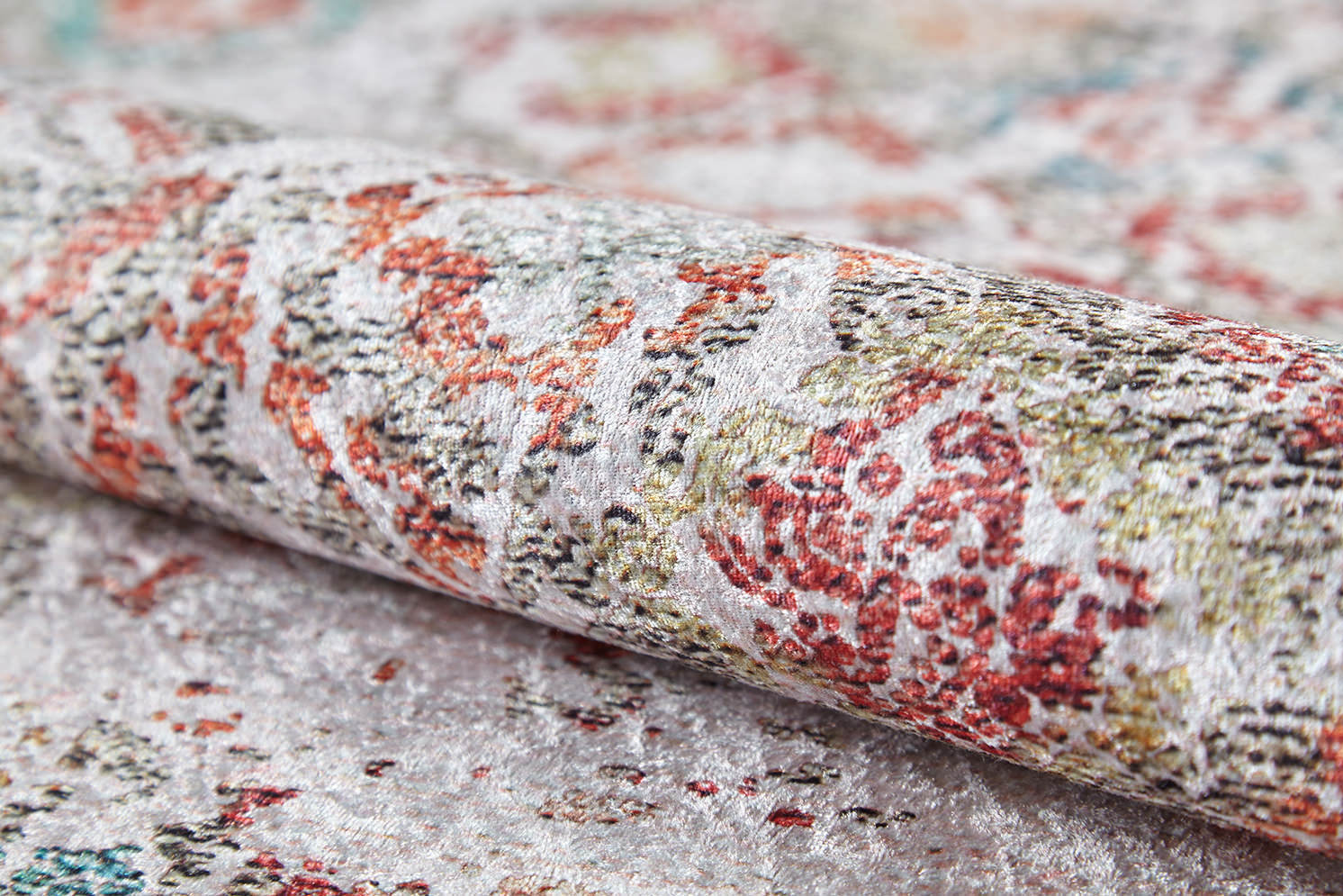 A close-up of the Vintage Cream - Machine-Washable Rug (JR5006), a flat weave with textured surface and red, green, and beige floral patterns on a light background—ideal for those seeking easy-care cream and beige rugs.