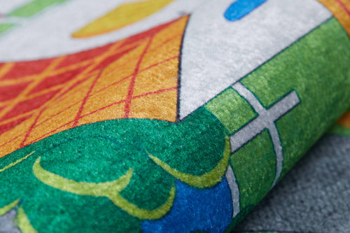 Load image 1 in gallery view. Close-up of the Zooming Metropolis - Machine-Washable Rug JRC012, featuring vibrant geometric patterns in green, orange, white, blue, and yellow—perfect for high-traffic areas thanks to its durable and washable design.